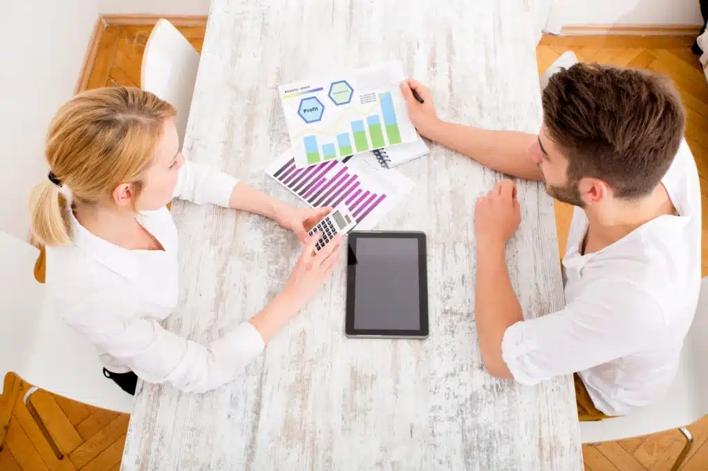 A group of marketing professionals collaborating in a modern office setting. The image represents the benefits of hiring a digital marketing agency, showcasing teamwork and strategy development, comparing agency vs in-house marketing approaches.