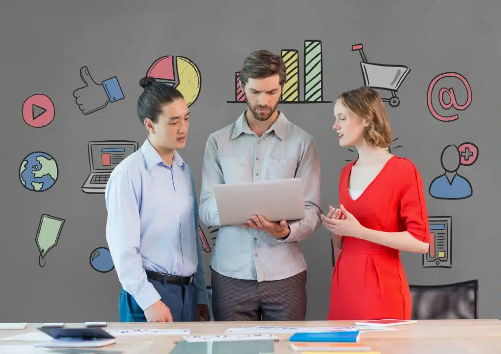 A team of three professionals discussing strategies on a laptop, with icons in the background representing digital marketing concepts like analytics, e-commerce, and social media. Perfect for blogs on hiring a digital marketing agency and the benefits of agency vs in-house marketing